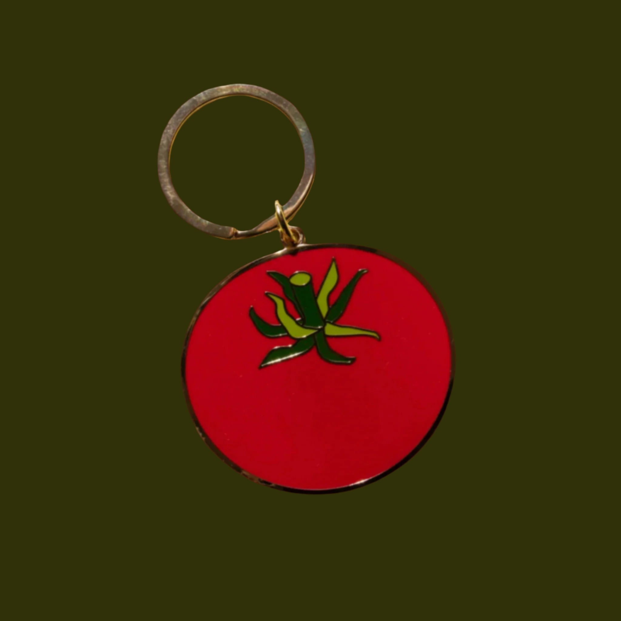 A tomato shaped enamel keychain. 