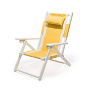 A white and yellow folding beach chair with a zip back pocket and a headrest pillow.