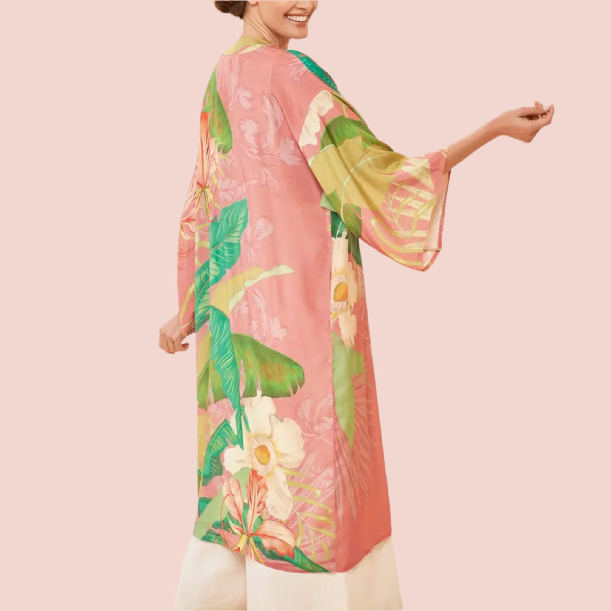 A green and apricot colored kimono robe with a tropical floral and foliage print. 