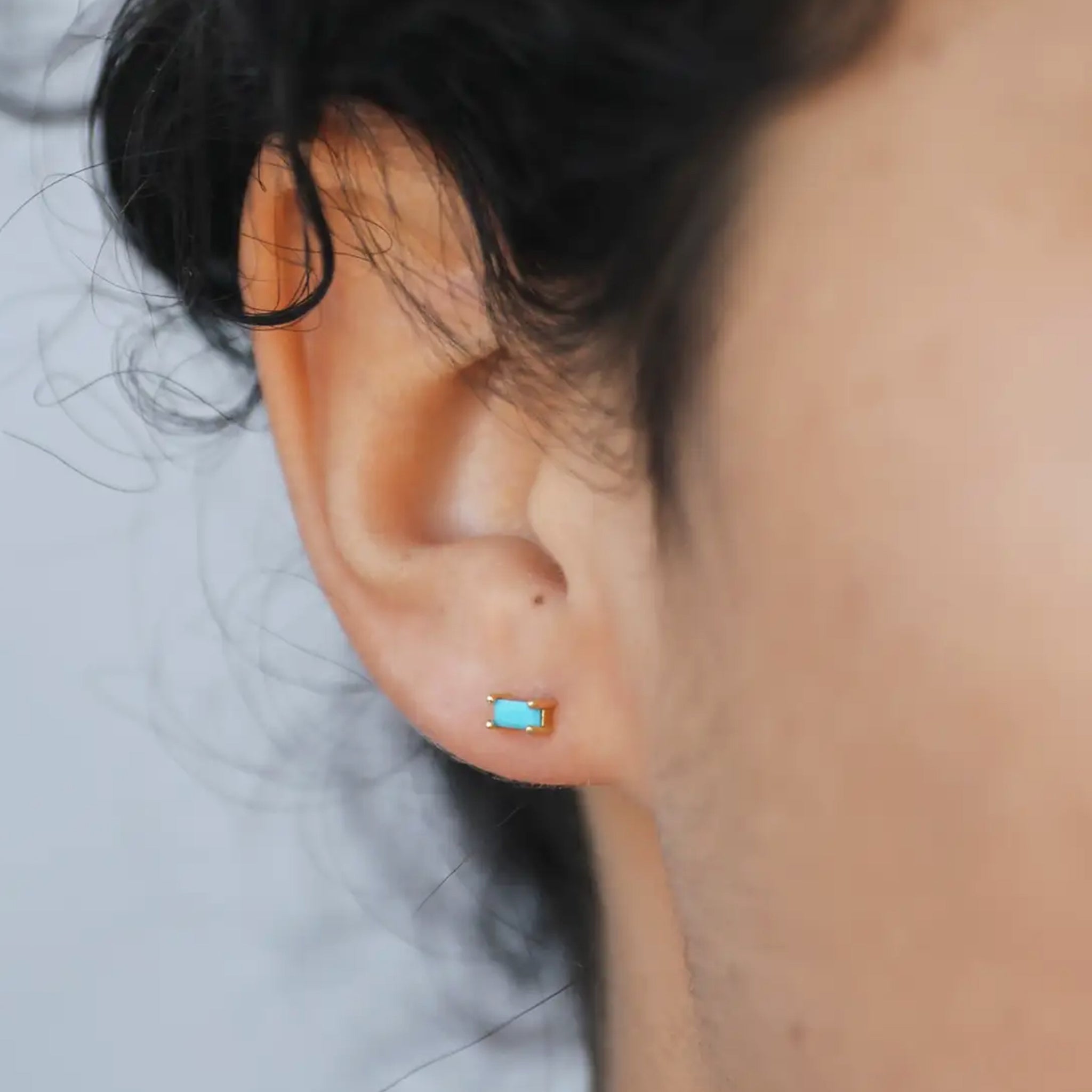 A pair of baguette shaped turquoise stone earrings. 