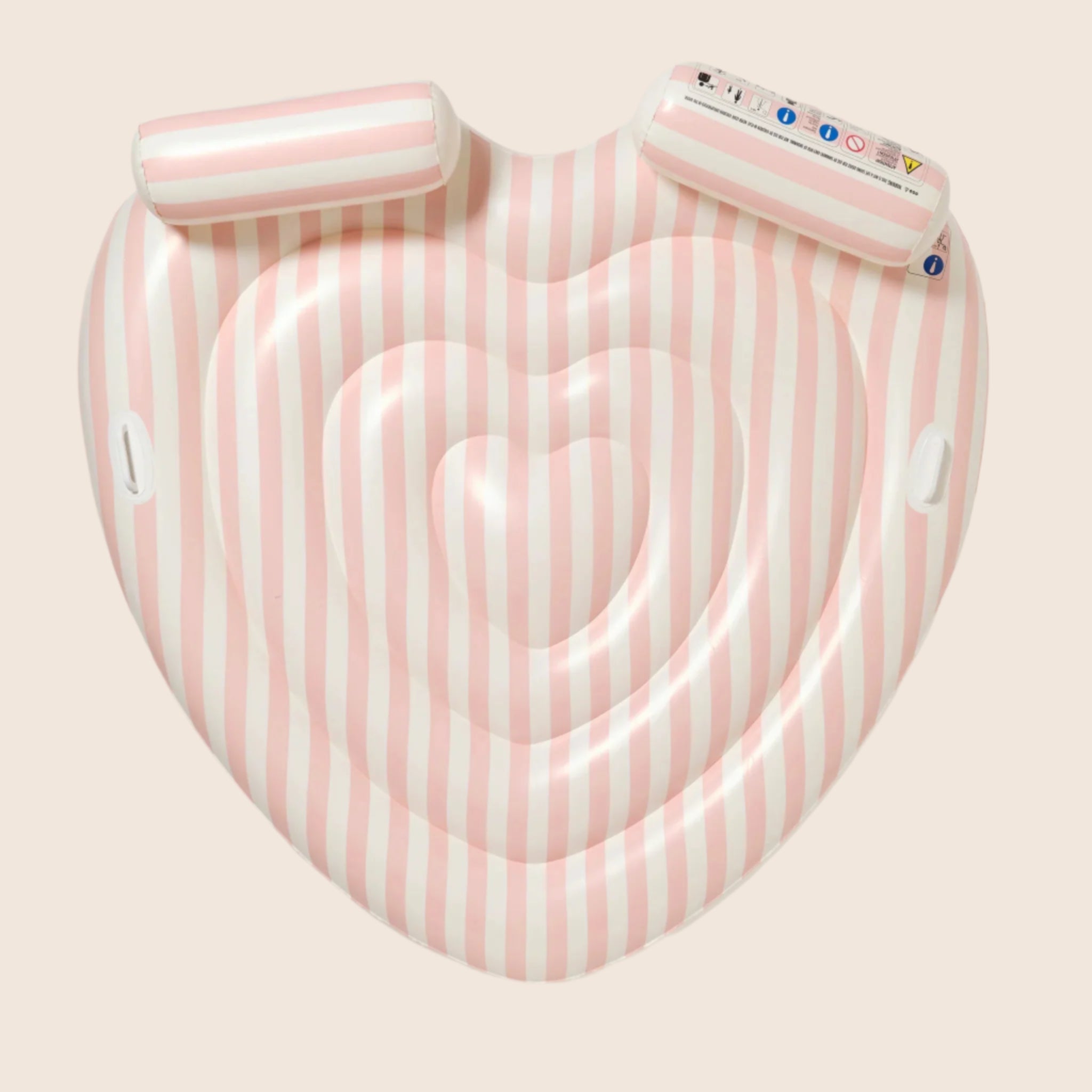 A heart shaped pool float with pink and white stripes and two neck rests.