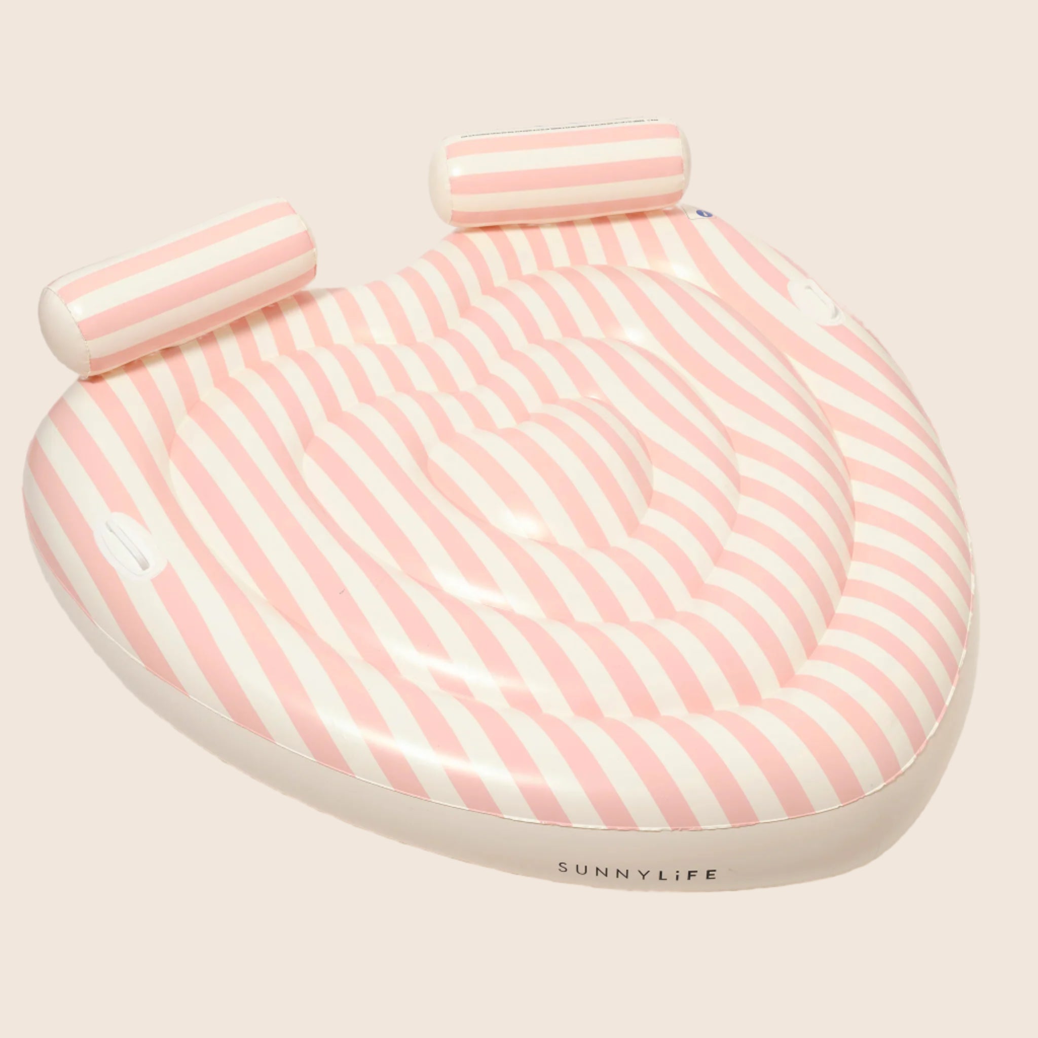 A heart shaped pool float with pink and white stripes and two neck rests.