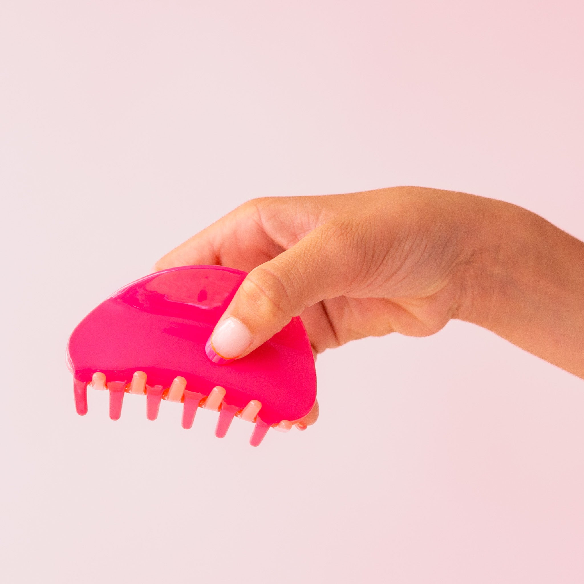 A two-toned, pink and light pink claw clip with rounded edges.