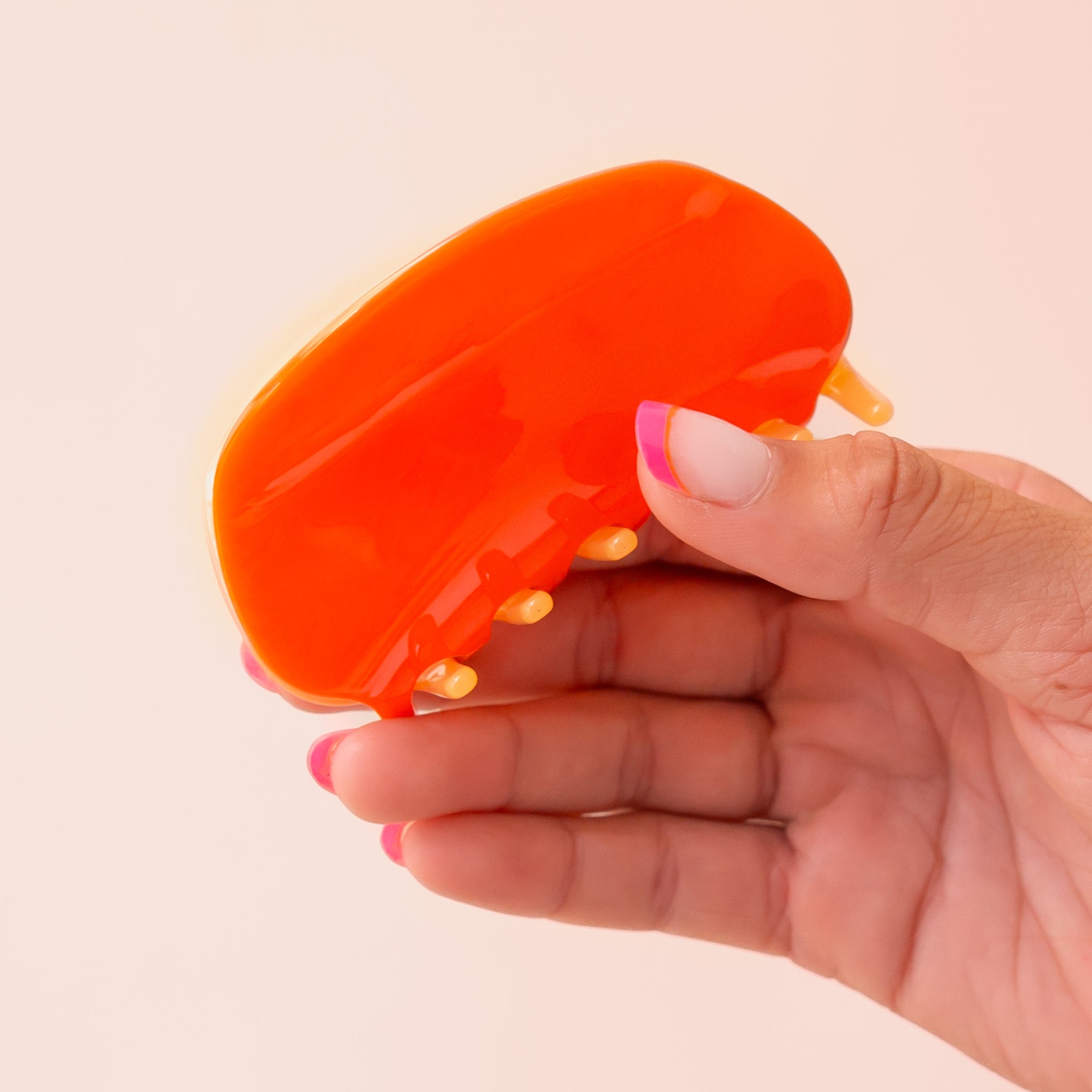 A two-toned rounded claw clip in shades of orange.