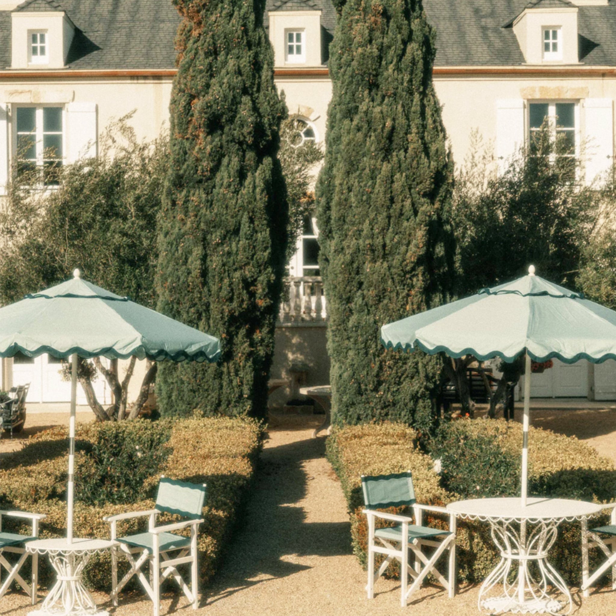 A green and darker green lined umbrella.