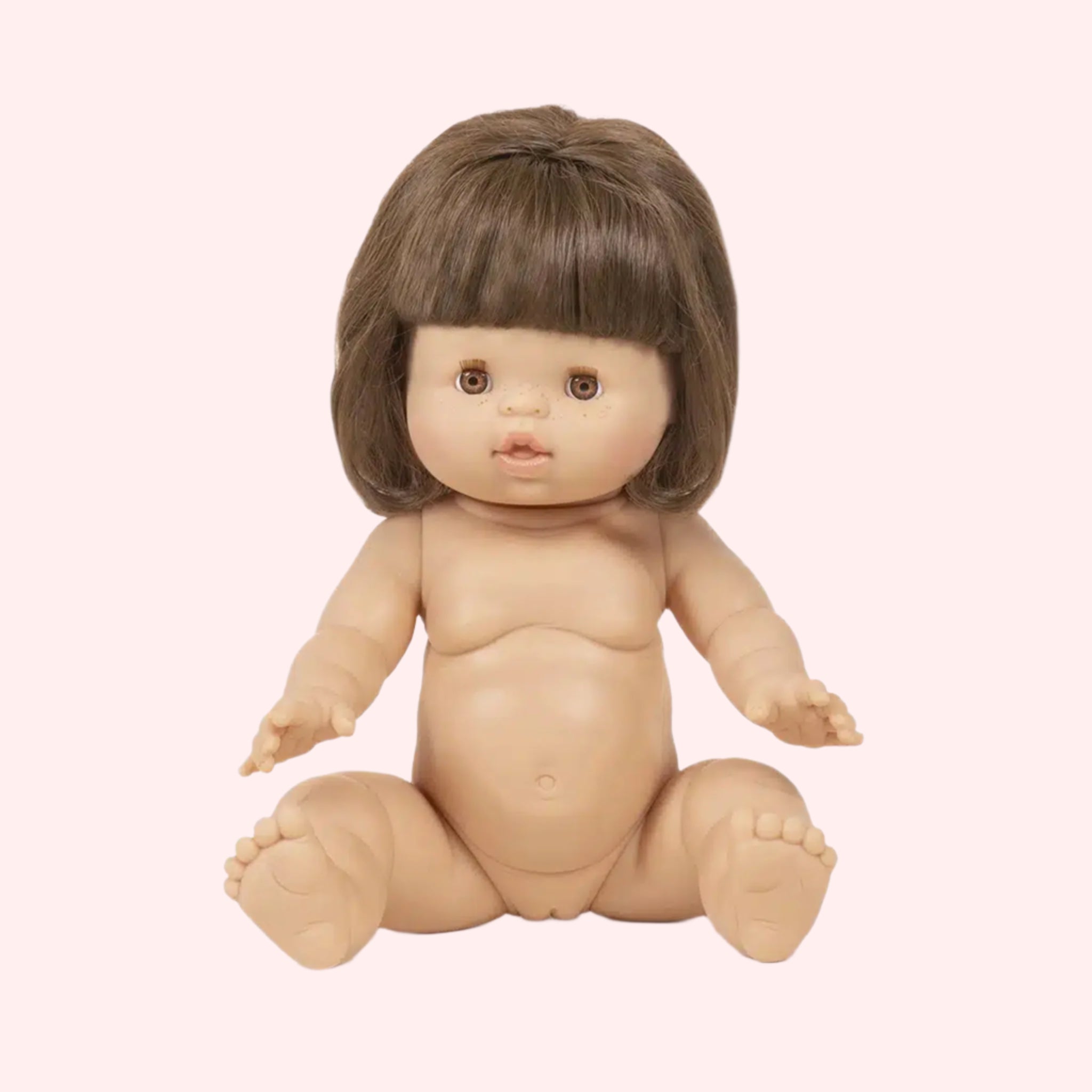 A baby girl doll with a brown braided hairstyle.