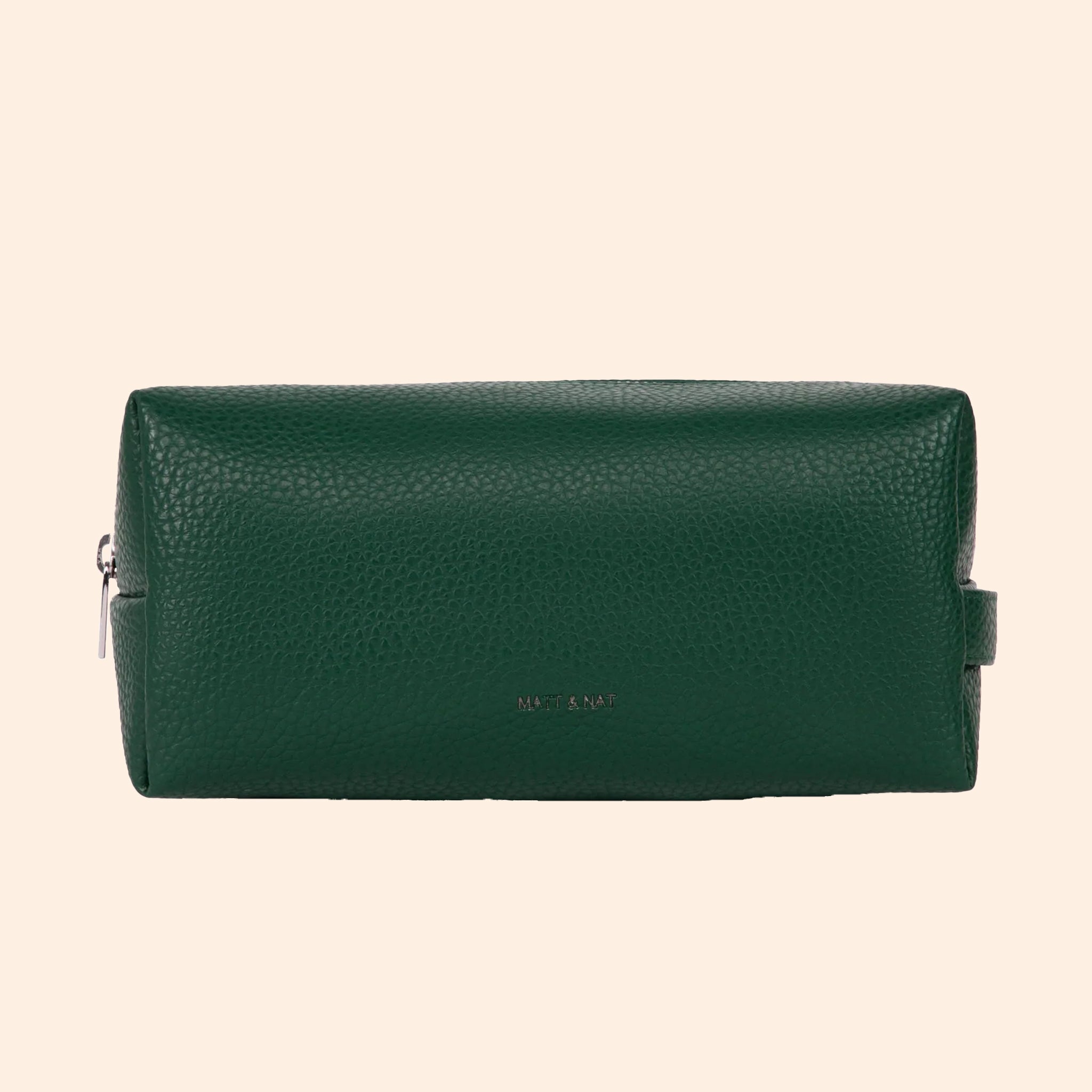 An emerald green vegan leather cosmetic case with a zipper closure. 