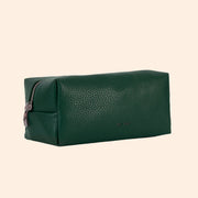 An emerald green vegan leather cosmetic case with a zipper closure. 