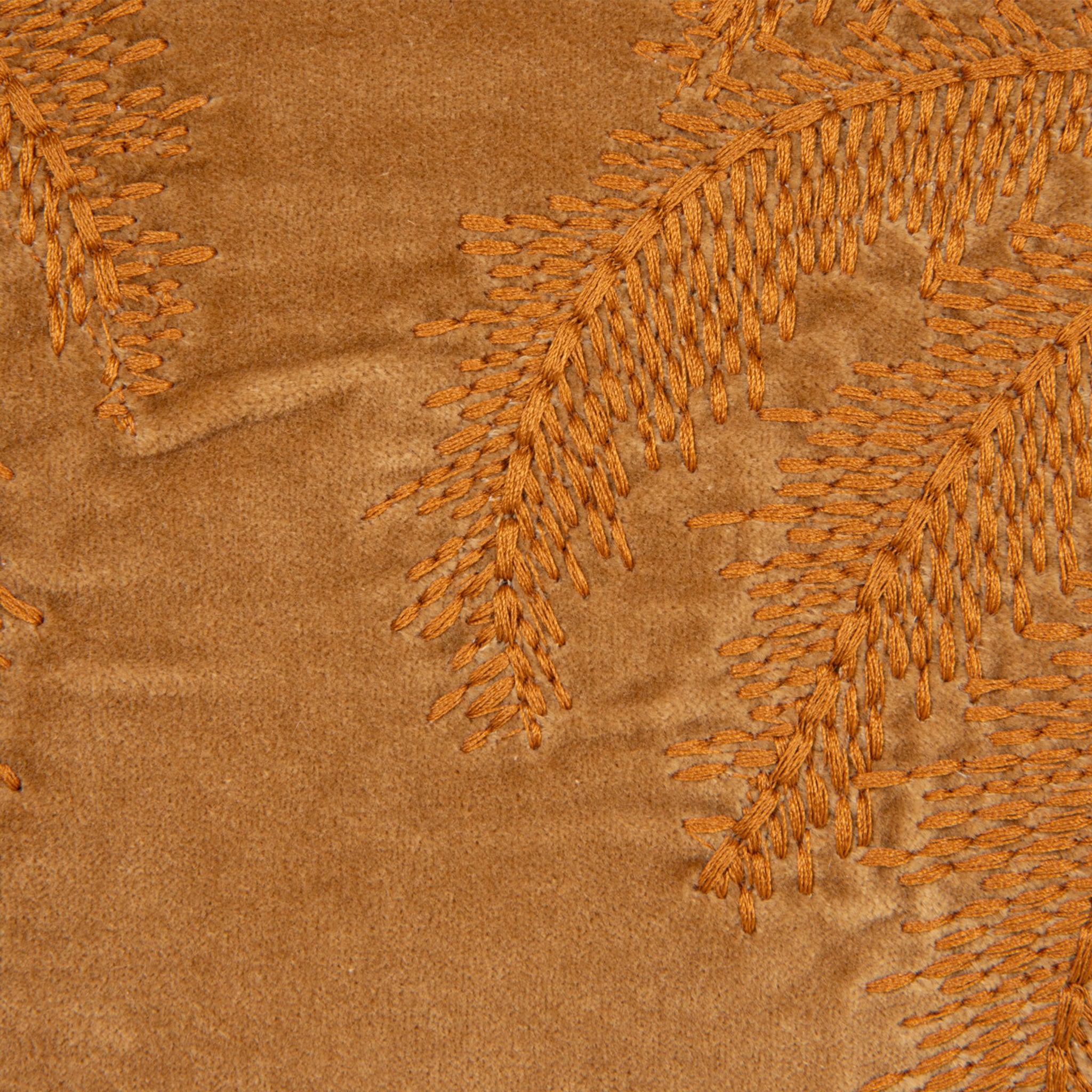 A burnt orange velvet pillow with embroidered orange palm trees, a removable cover that features a zip detail. 