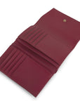 On a white background is a dark cherry red wallet with 10 card slots. 