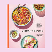 Front cover of cookbook reading 'healthful recipes for bright, nourishing meals, vibrant & Pure'. The cover is a soft lilac with tangerine orange binding. Pictured around the text are smoothie bowl, plated toast and more. 