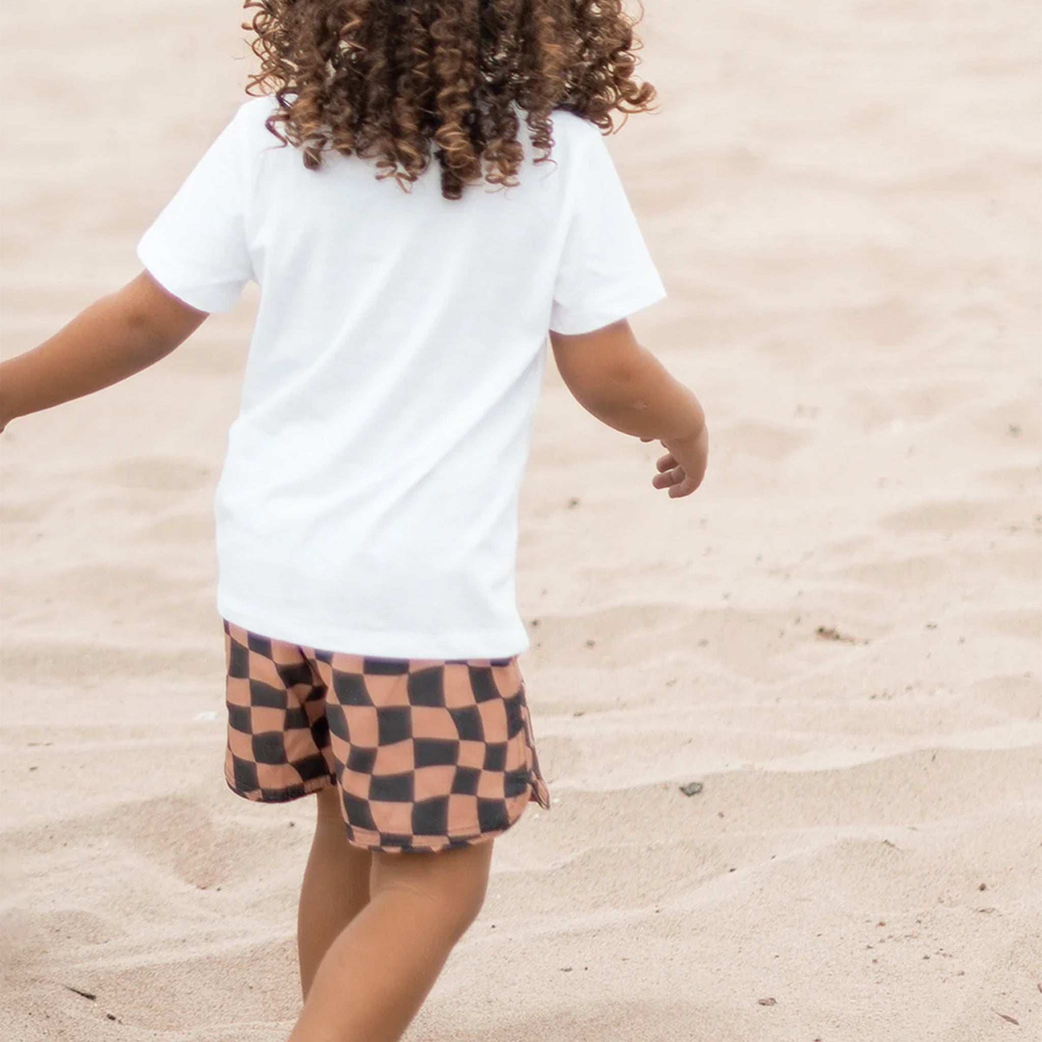 A brown and black wavy checkered print patterned boardshort.