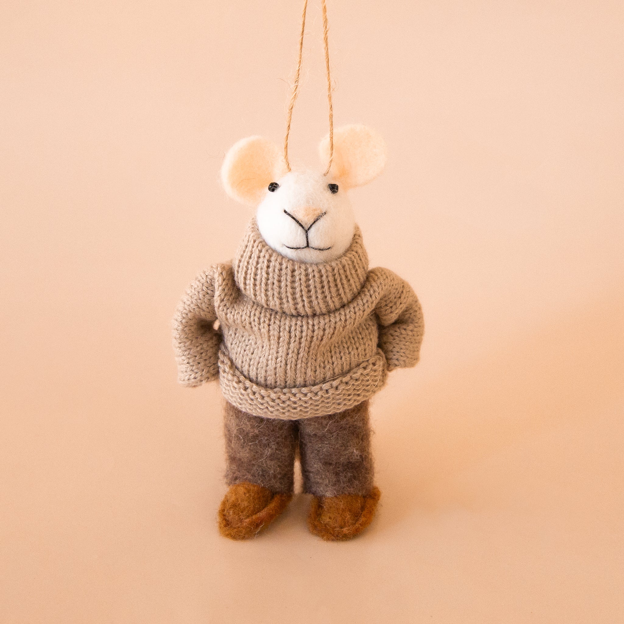 A white mouse shaped wool ornament wearing a sweater and wool pants. 