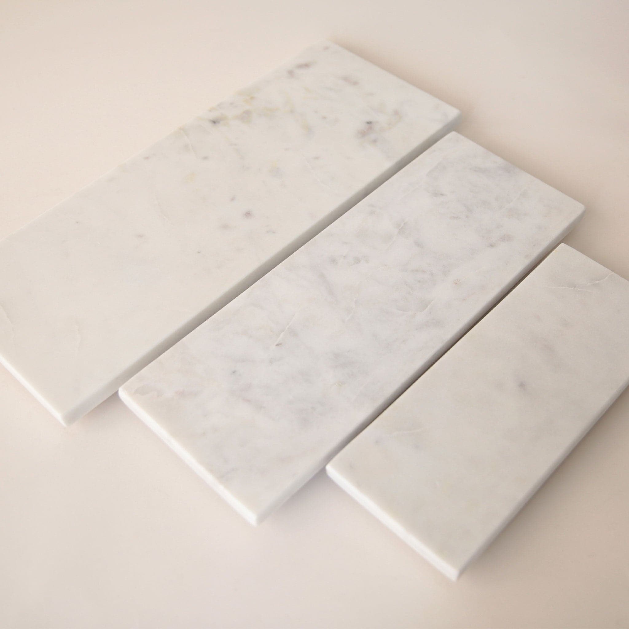 A white, rectangular marble tray in three different sizes. Each tray sold separately.