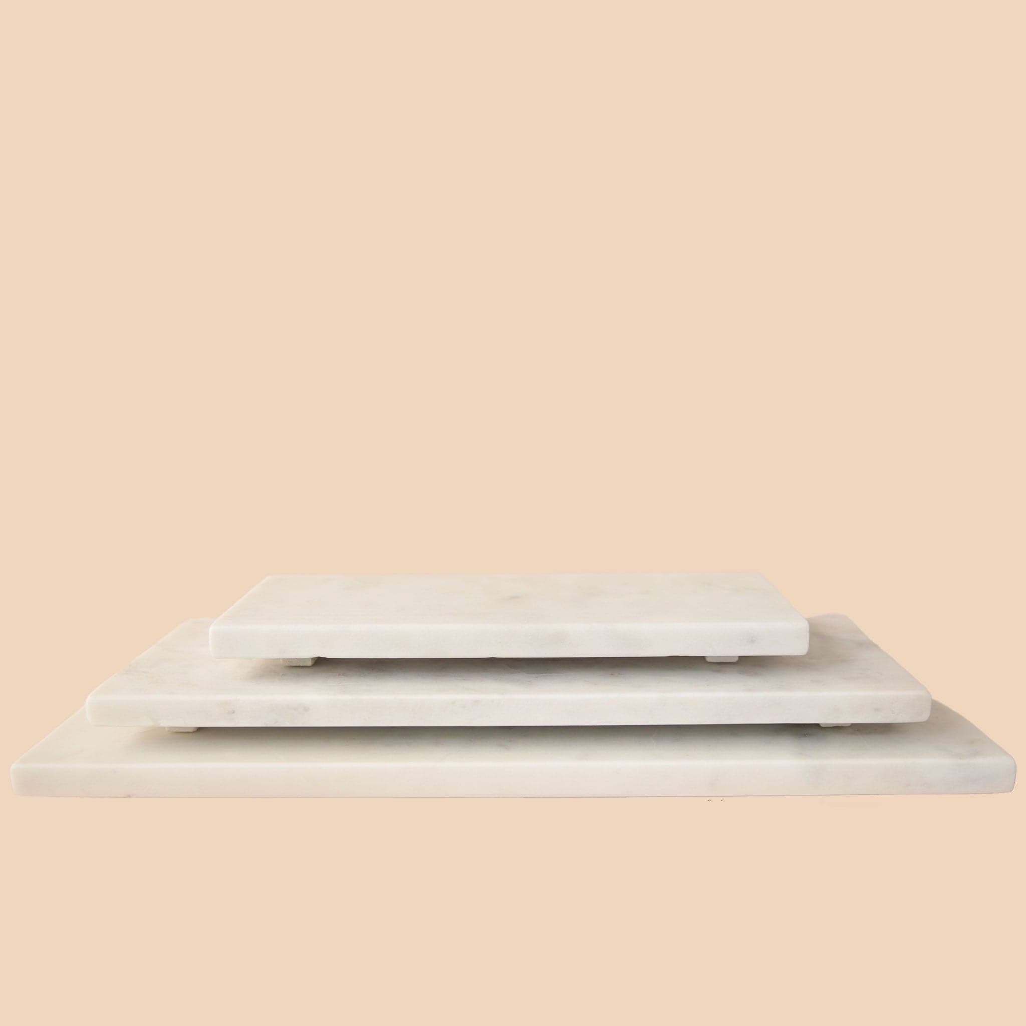 A white, rectangular marble tray in three different sizes. Each tray sold separately. 