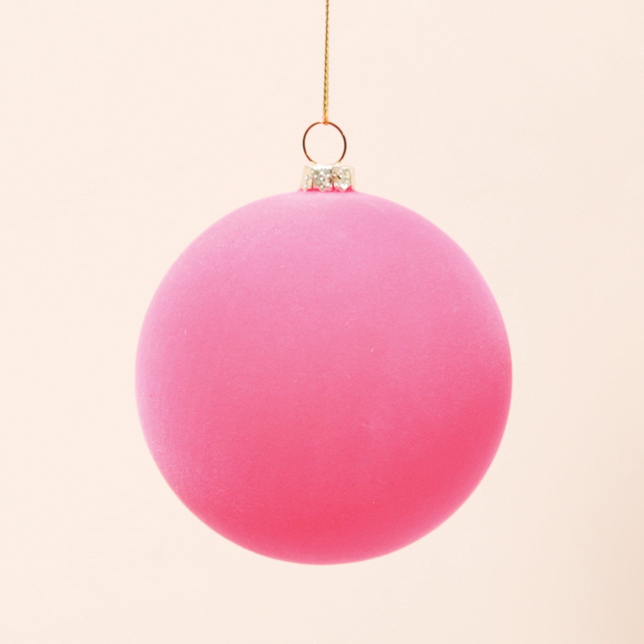 A classic ball ornament with a hot pink velvety finish, a gold clasp holding a gold loop that&#39;s about 3&quot; for hanging.