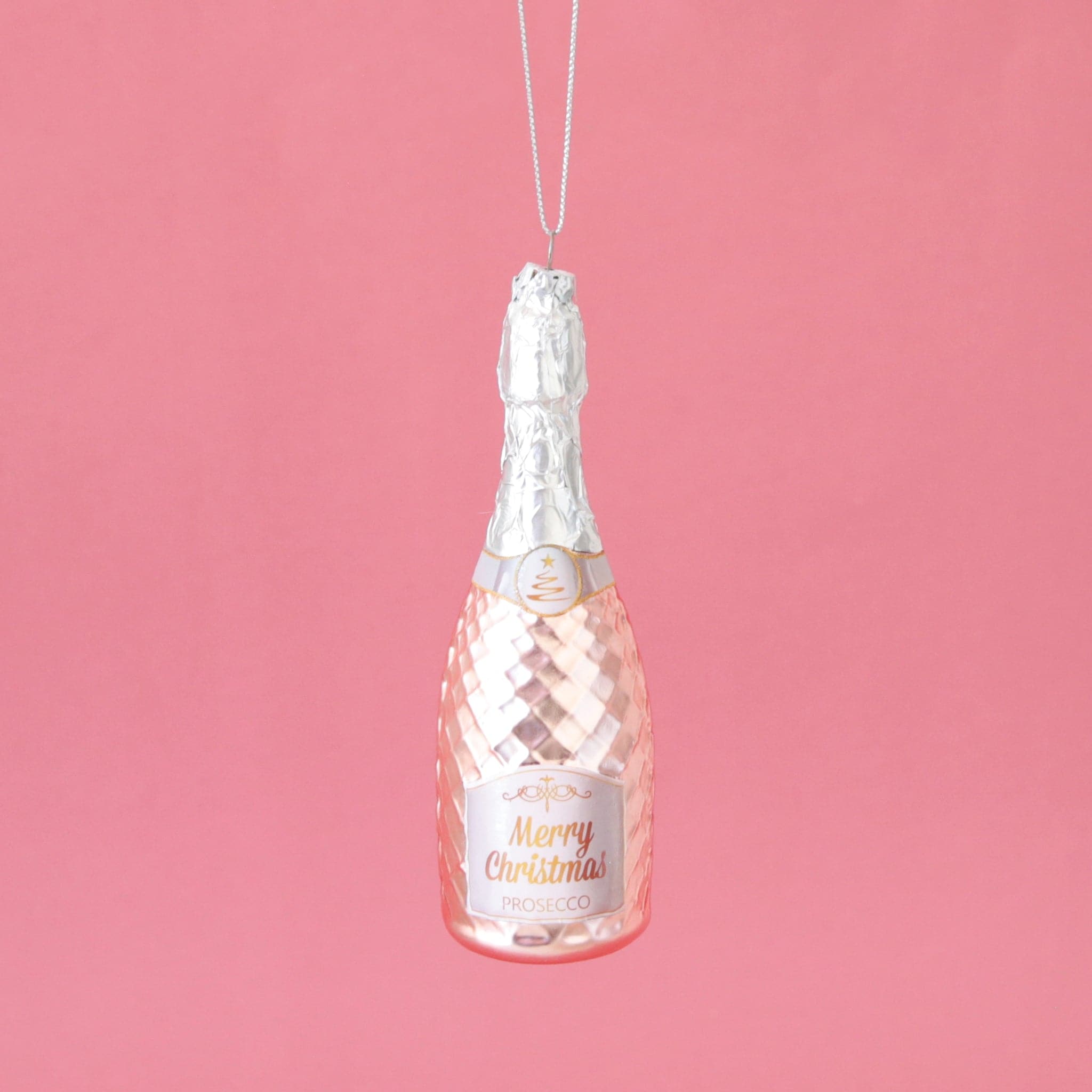 A pink glass Prosecco ornament with a silver top and pink base along with a string for hanging.