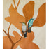 Unclose of original painting with silhouetted orange ombre leaves and branches with two realistic hummingbirds, one green and one blue, sitting on a branch, and pale gold wash backdrop.