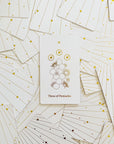 A cream box of 78 Tarot cards with an illustration of two hands and a star in between. All cards are beautifully illustrated with descriptions underneath and detailed with gold foiling.