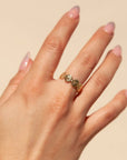 A ring made up of small gold daisy flowers connecting acting as the band of the ring.