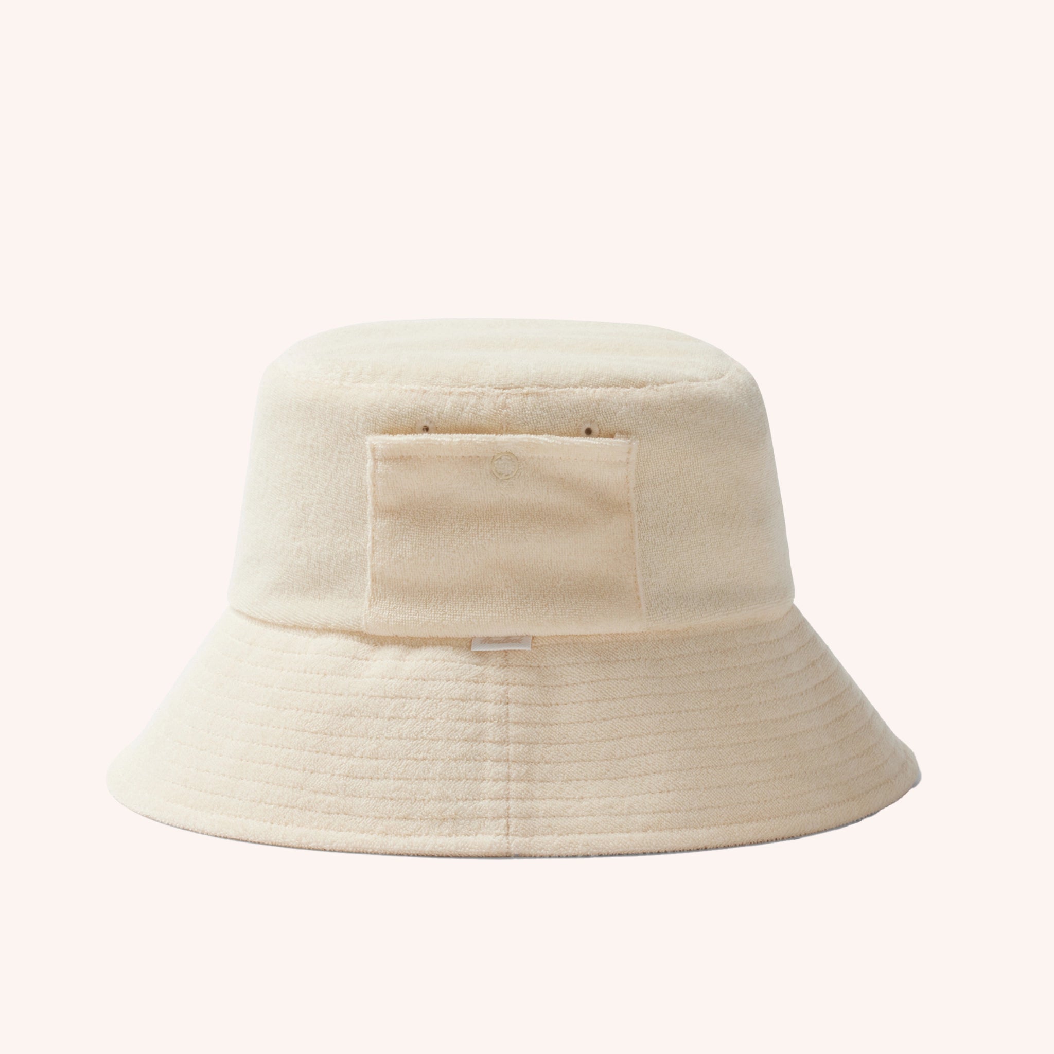 An ivory cotton bucket hat with a ribbed brim and a single side pocket.