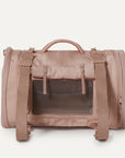 A nude colored pet carrier with an outside pocket for storing essentials and a zipper opening on both ends along with a handle on the top and two attachments for a shoulder strap option. There is a mesh opening on the side of the carrier that can also be covered with a folded flap.
