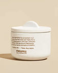 The back of the white ceramic pinch pot that reads, "Hand-harvested by a women-run co-op int he Peruvian salt flats for a mild medium grind pink salt. Ethically made by Yolanda Curio Mendoza, sourced by Sara Herrada of SIMPLi.".